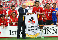 【明治安田Ｊ１ １ｓｔ 優勝セレモニー】明治安田生命保険相互会社の根岸 取締役 代表執行役社長より優勝ペナントを授与される阿部（浦和）（1/10）