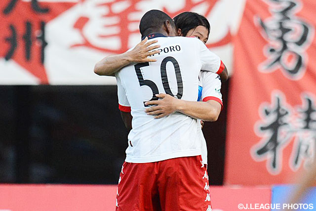  【明治安田Ｊ２ 第30節 熊本vs札幌】先制点を決めナザリト（札幌）と抱き合う今季初ゴールの前　貴之（札幌）（2/4）